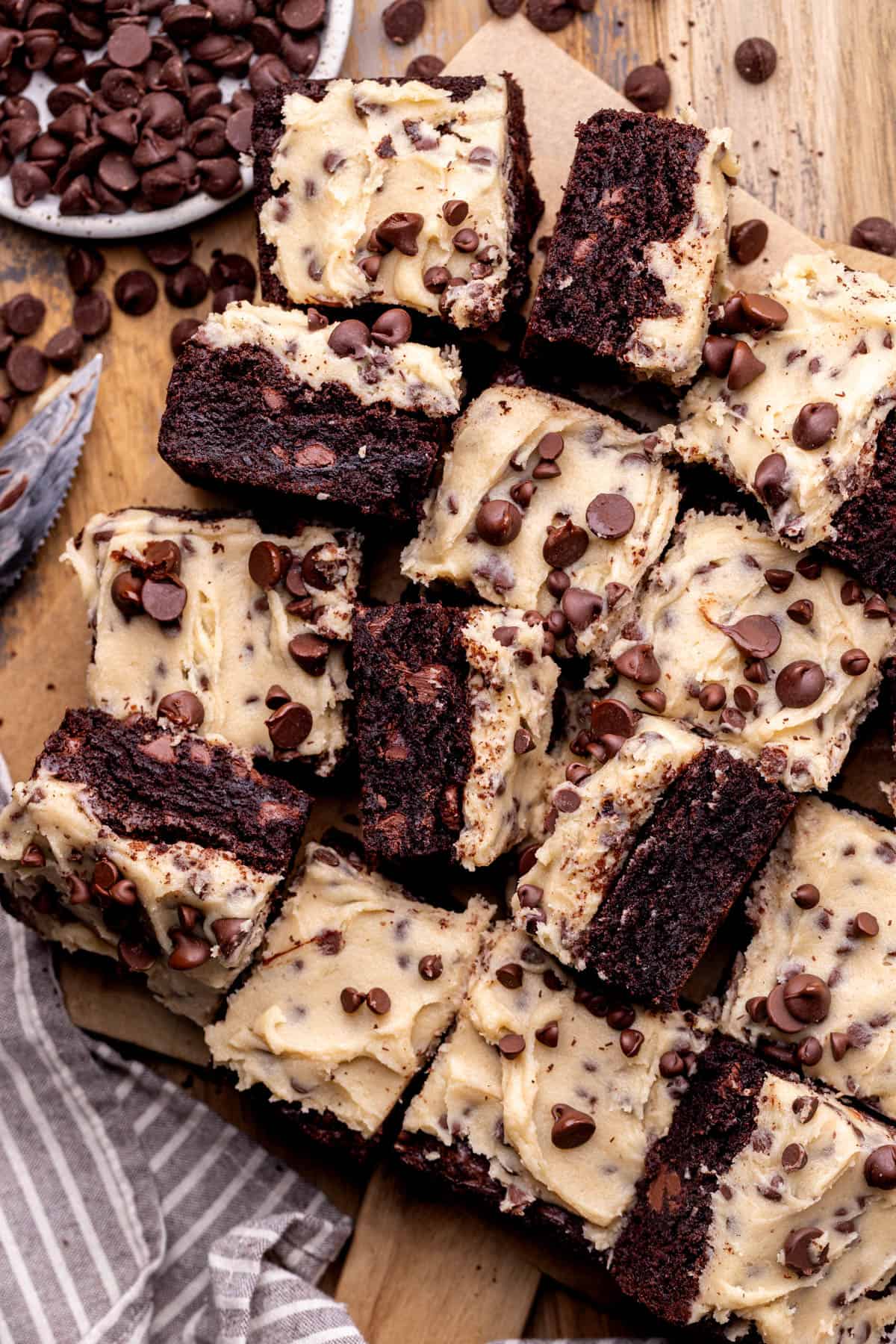 Cookie dough brownies on a wood platter.