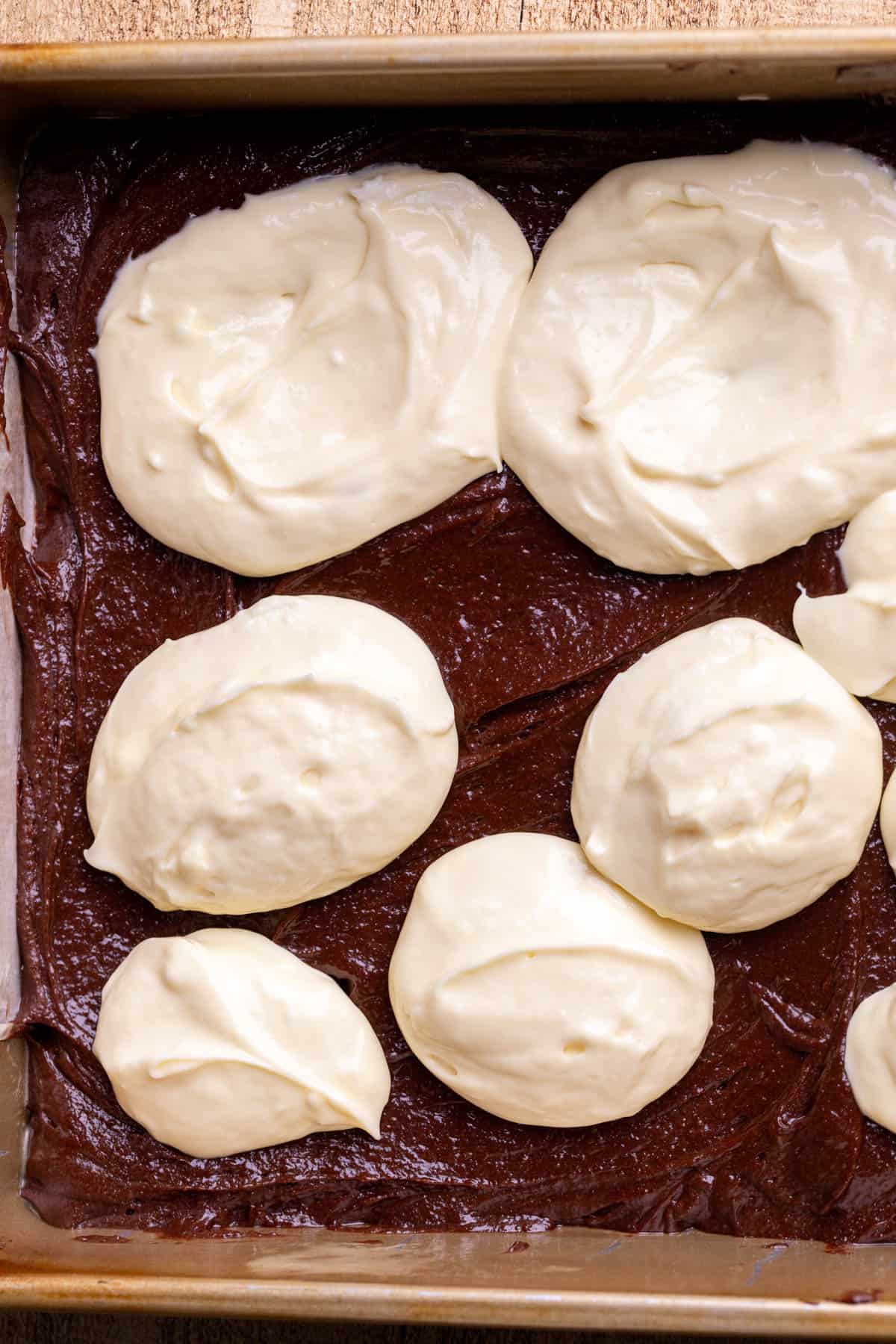 Cheesecake dollops on brownie batter.