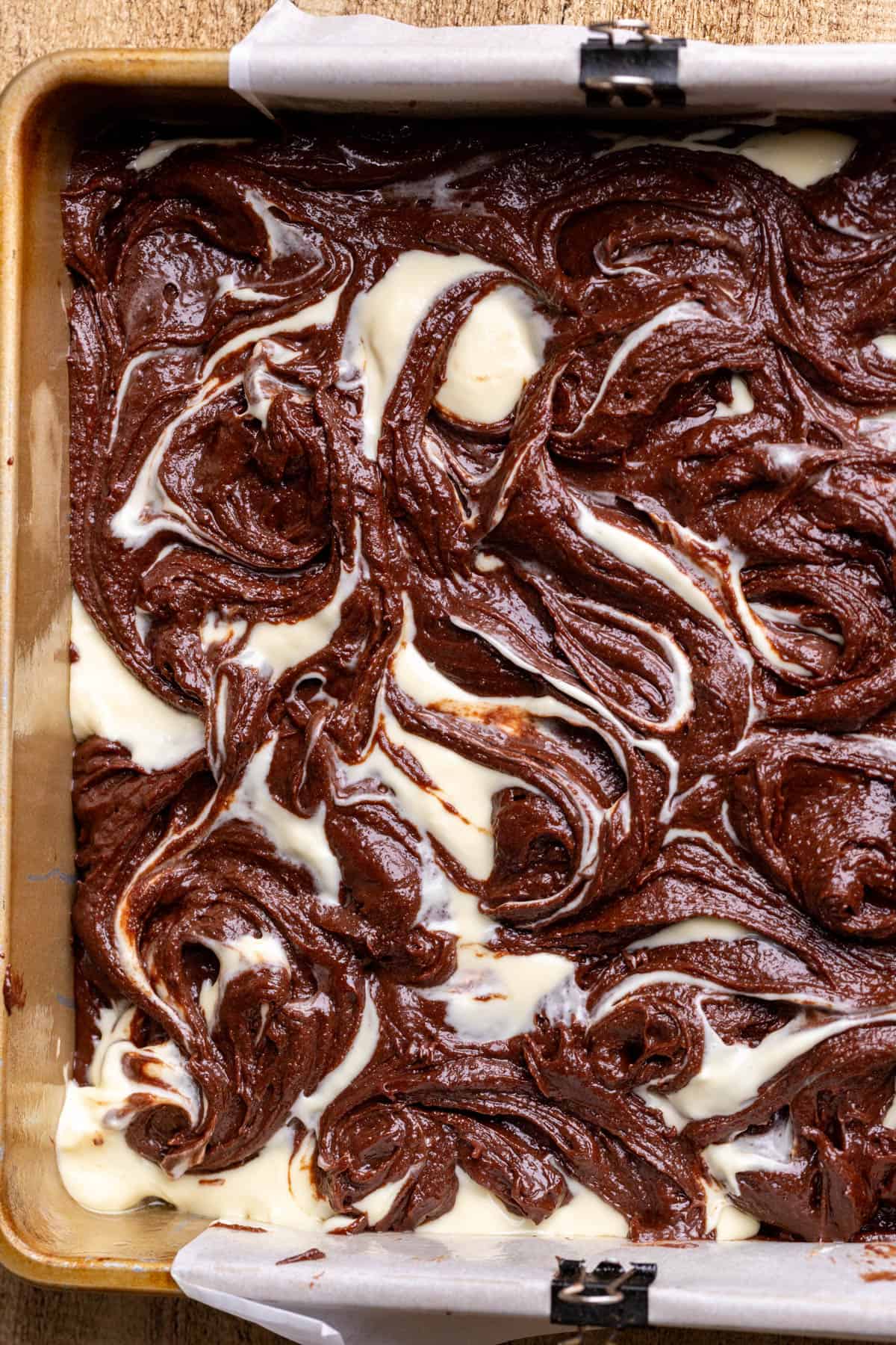 Swirled brownie batter in a pan.