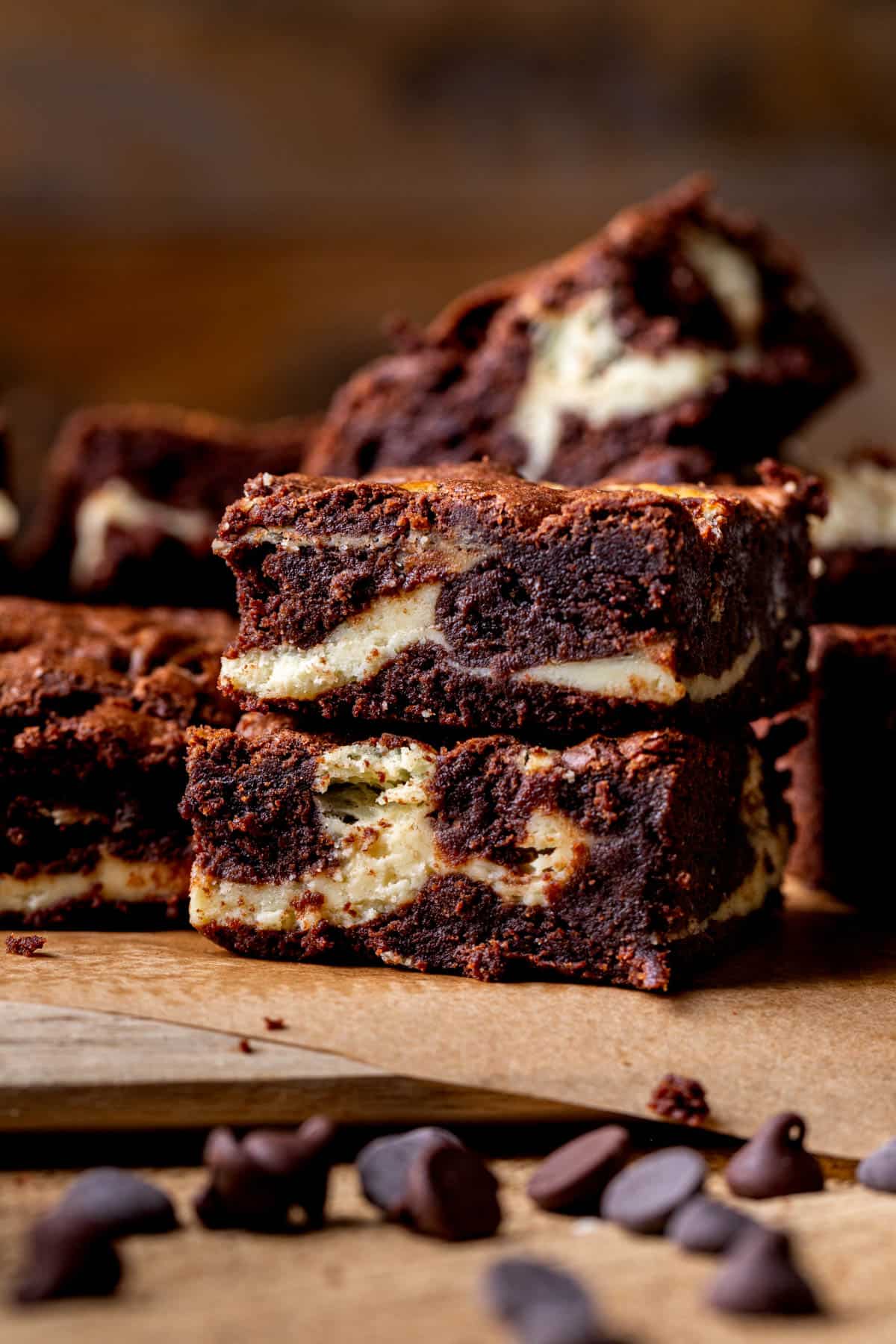 Stack of brownies on a wood board.