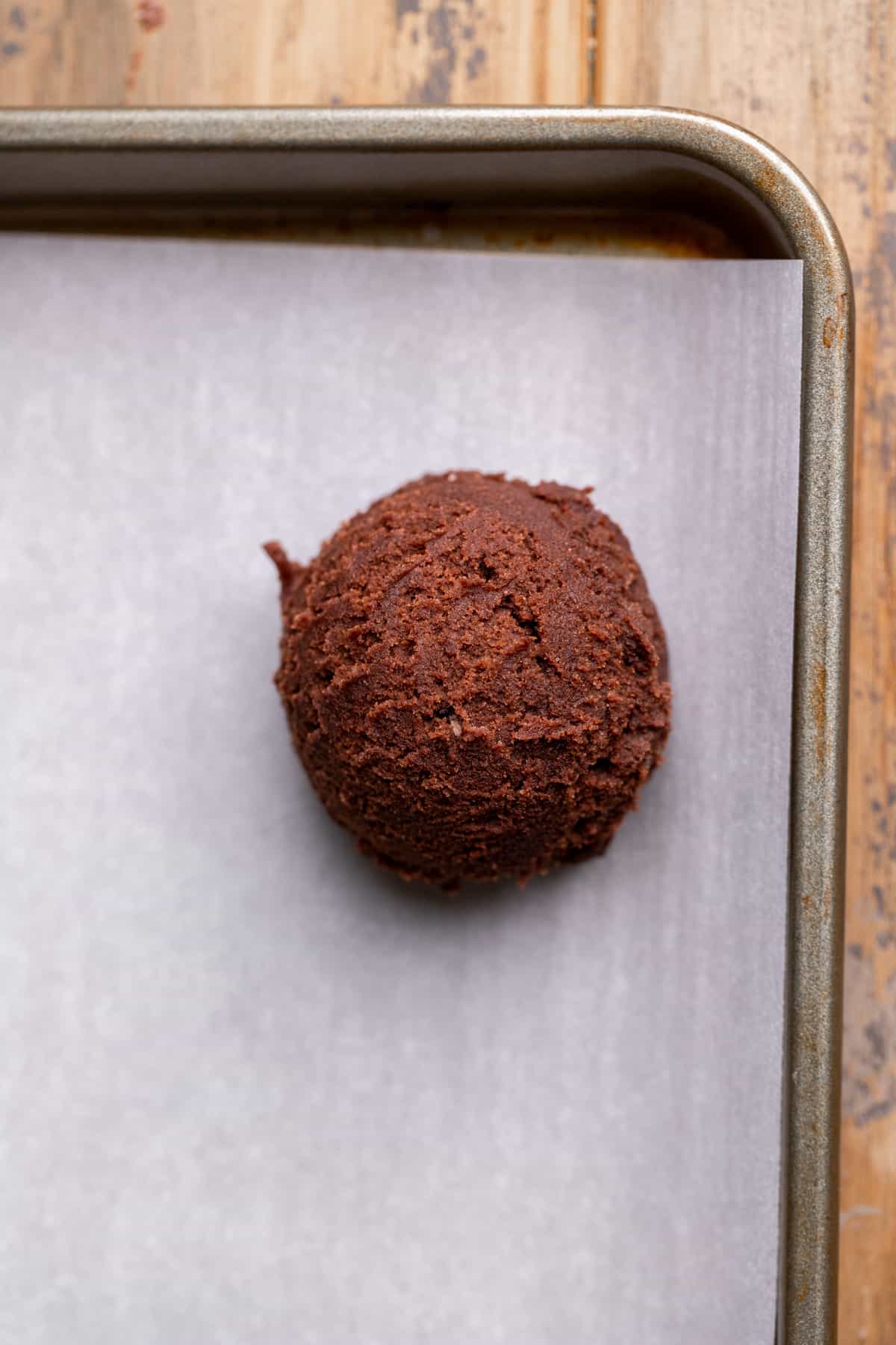 Cookie dough ball on a cookie sheet.