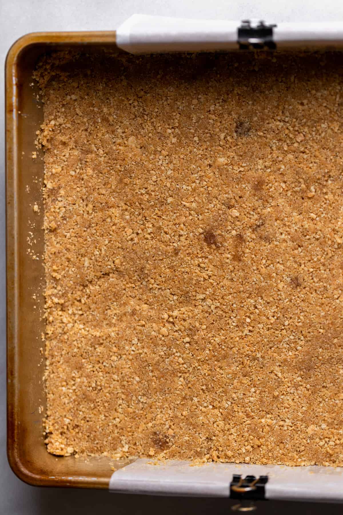 Graham cracker crust in a pan.