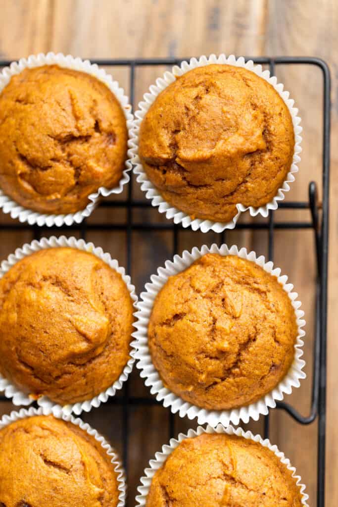 Baked cupcakes on a wire rack.