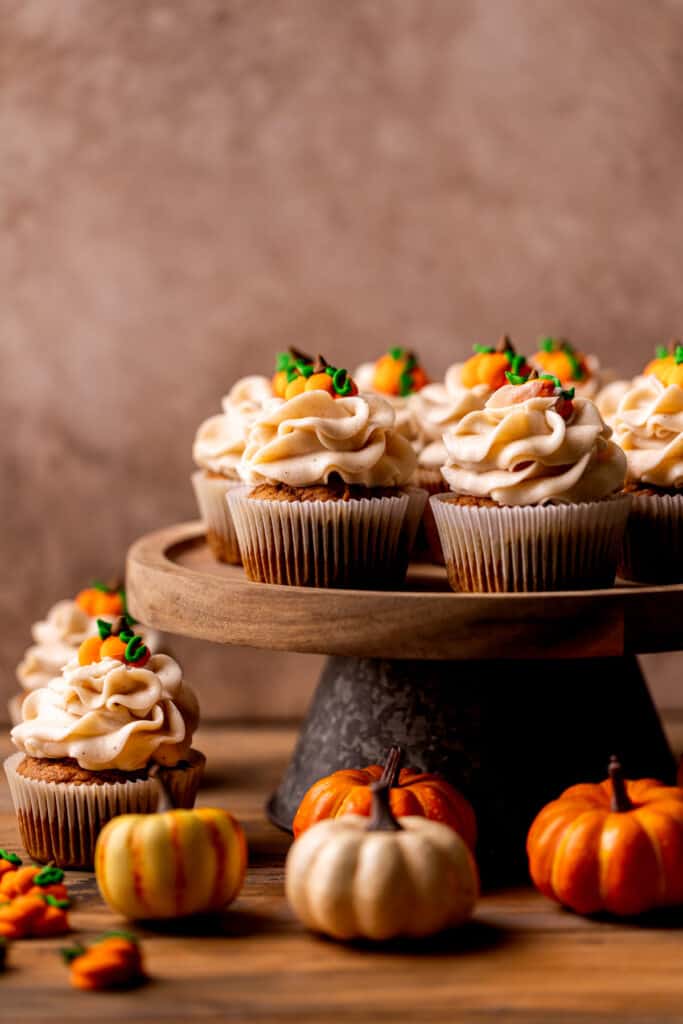 Pumpkin cupcakes on a cake stand.