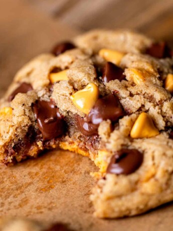 Bite missing from butterscotch chocolate chip cookies.
