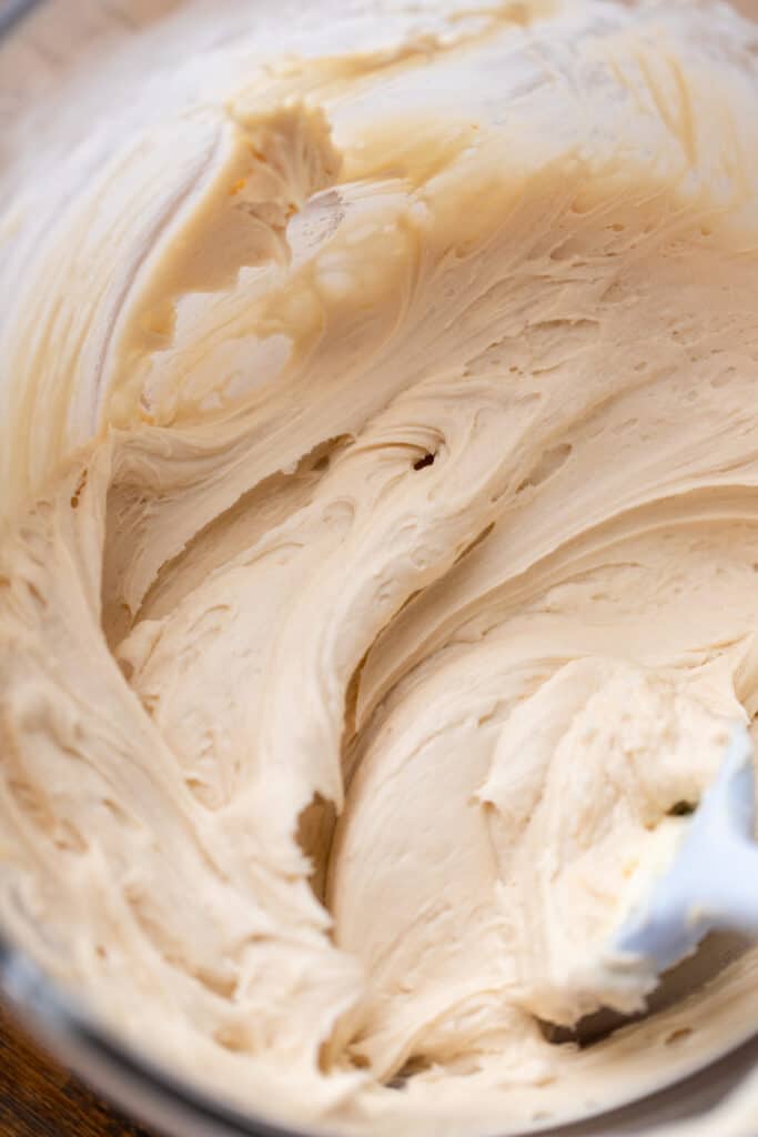Maple cream cheese frosting in a glass bowl.