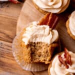 Top view of a maple bacon cupcake with a bite missing.