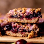 Stack of two cherry pie bars.