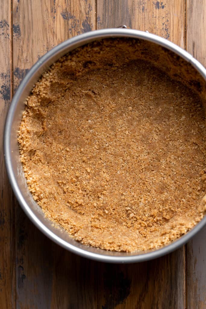 Graham cracker crust in a pan.