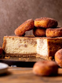 Apple cider cheesecake split open on a board.