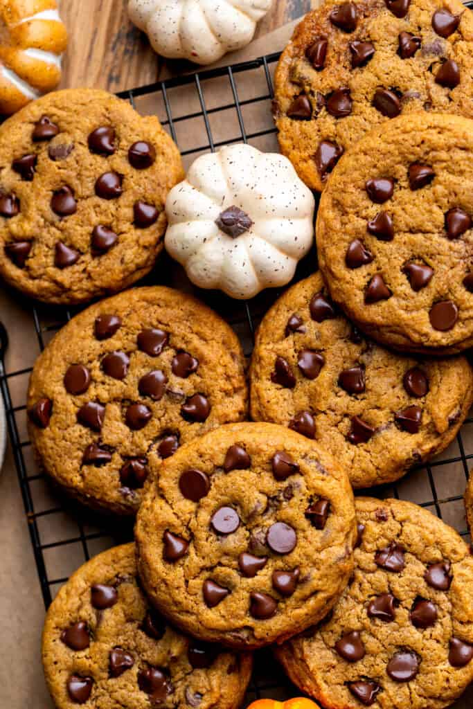 Top view of pumpkin chocolate chip cookies on a wire rack.
