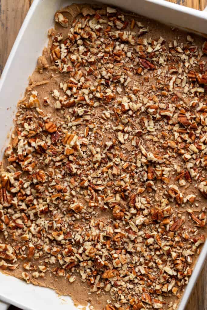 Sticky topping and pecans in a pan.