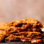 Stack of two pumpkin caramel cookies split in half.
