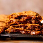 Stack of two pumpkin caramel cookies split in half.