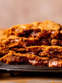 Stack of two pumpkin caramel cookies split in half.