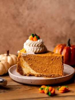 One slice of pumpkin cheesecake on a plate.