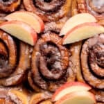 Apple cider cinnamon rolls in a pan.