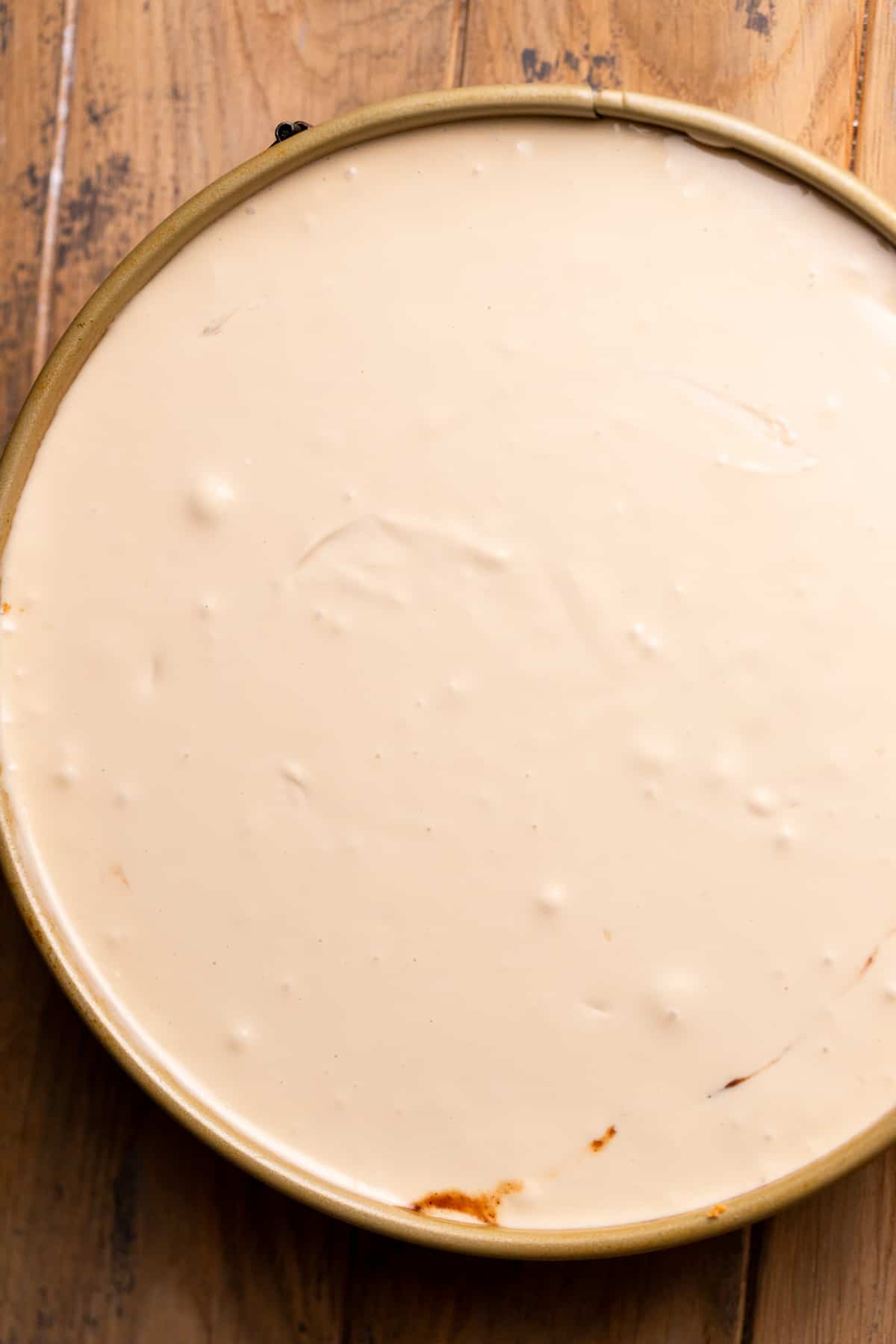 Cheesecake batter in a springform pan.