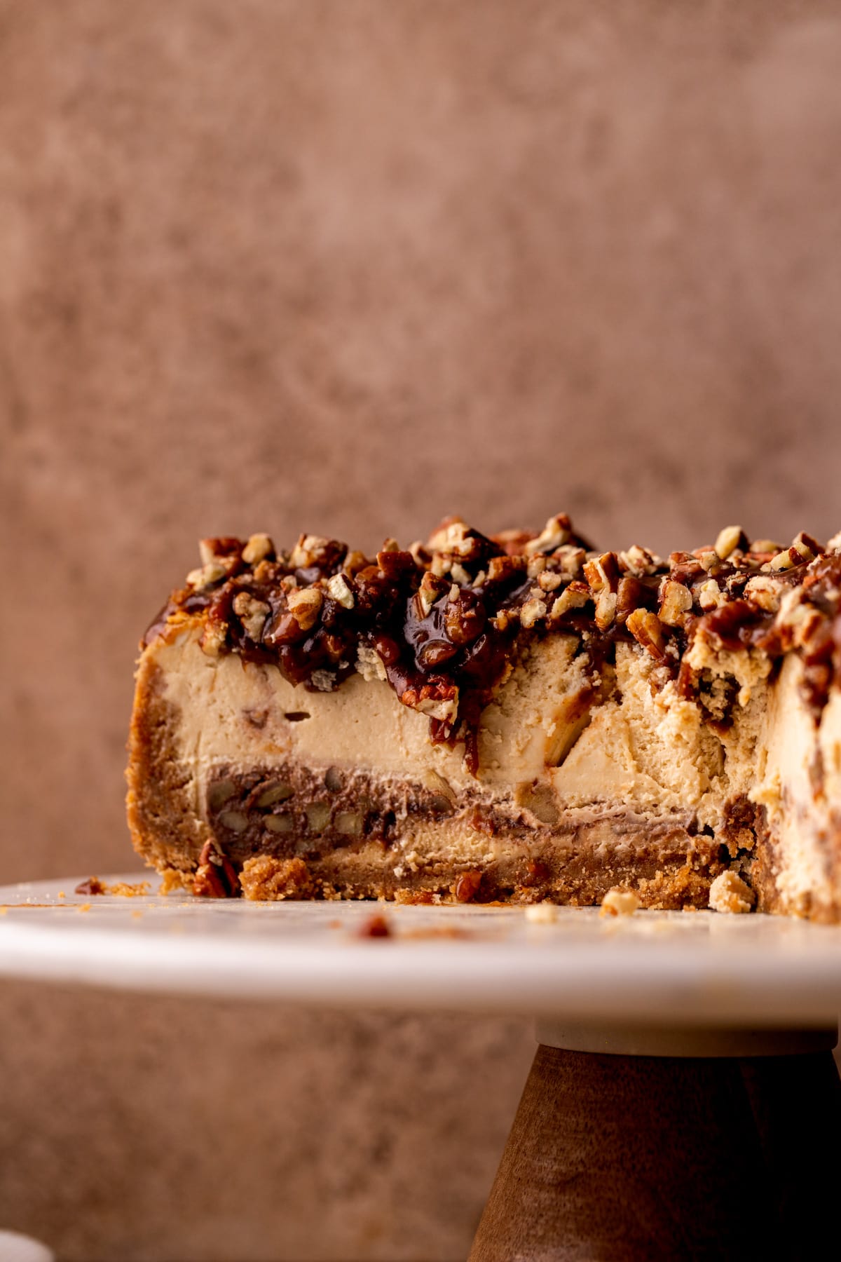 Close up of the side of pecan pie cheesecake.