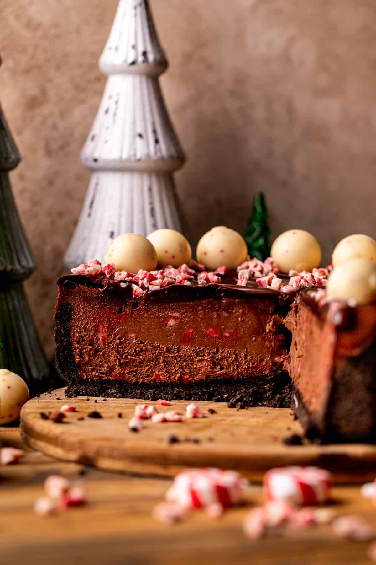 Chocolate peppermint cheesecake on a wood board.