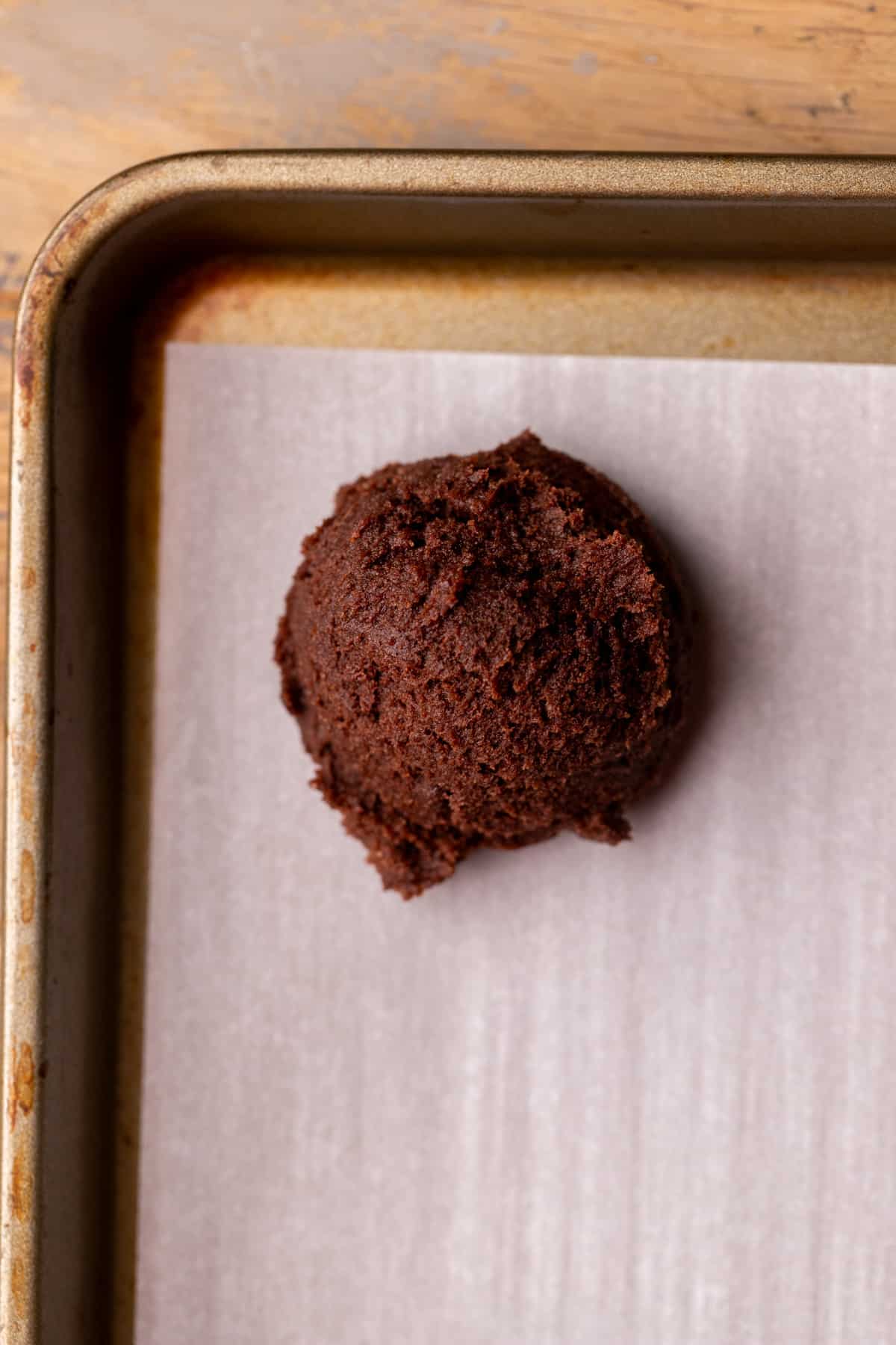 Chocolate cookie dough on a cookie sheet.