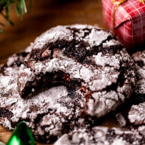Bite missing from chocolate crinkle cookie.