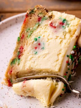 Fork inserted into sugar cookie cheesecake.