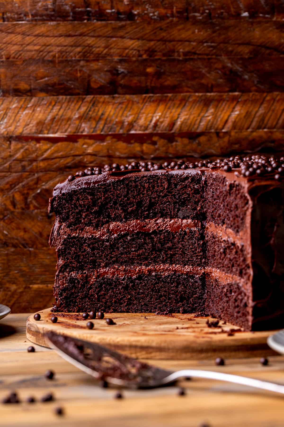 Chocolate cake on a wooden platter.