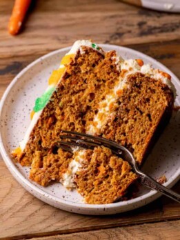 One slice of the best carrot cake with a fork inserted.