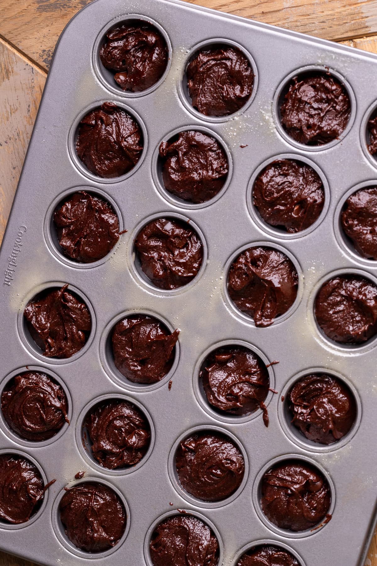 Brownie batter in a mini muffin pan.