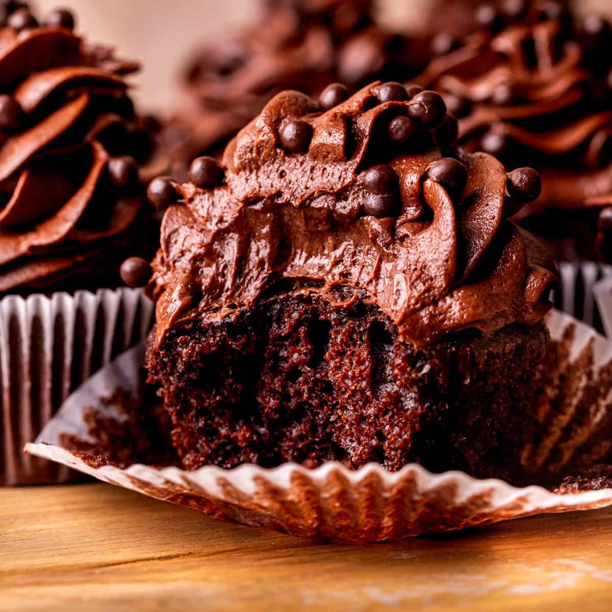 One chocolate cupcake with a bite missing.