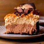 Side view of chocolate peanut butter pie on a plate.