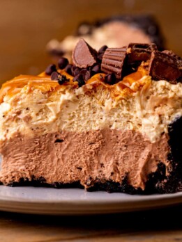 Side view of chocolate peanut butter pie on a plate.