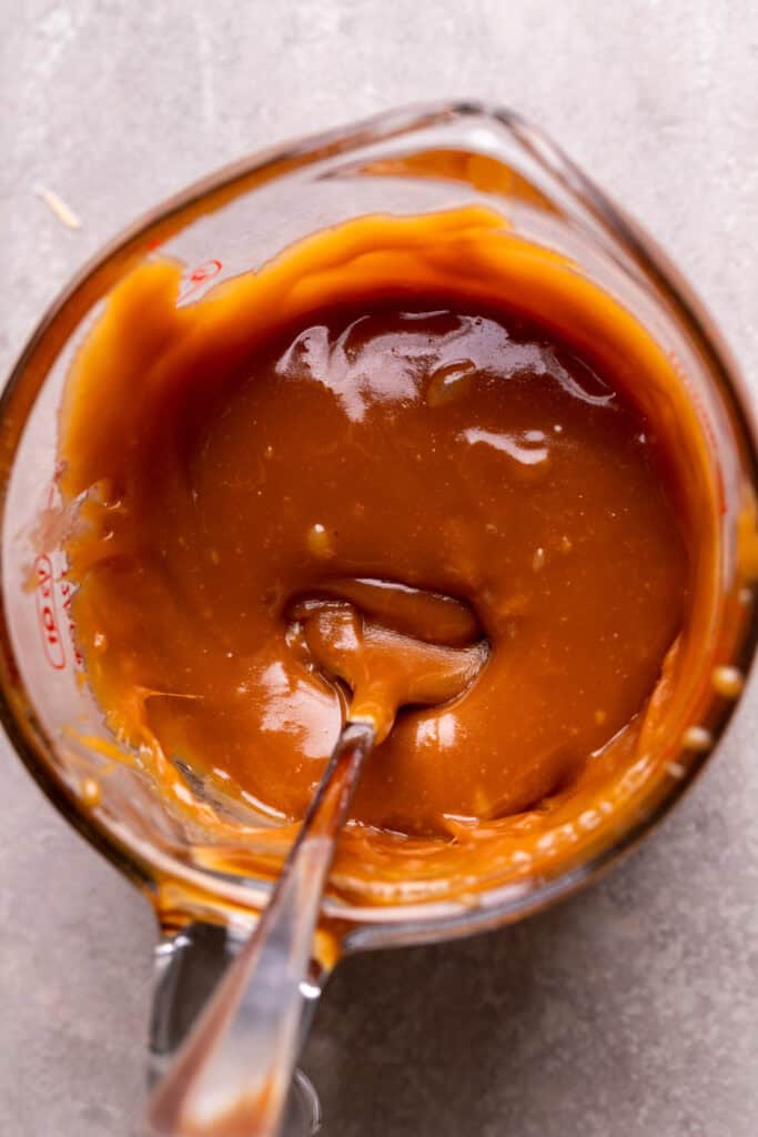 Caramel in a glass measuring cup.