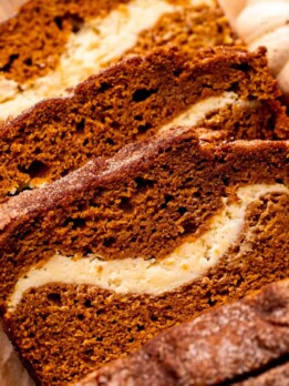Top view of three slices of pumpkin cream cheese bread.
