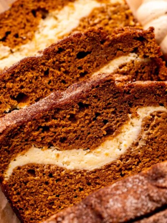 Top view of three slices of pumpkin cream cheese bread.