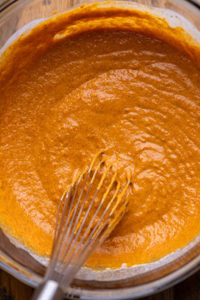 Pumpkin pie batter in a glass bowl.