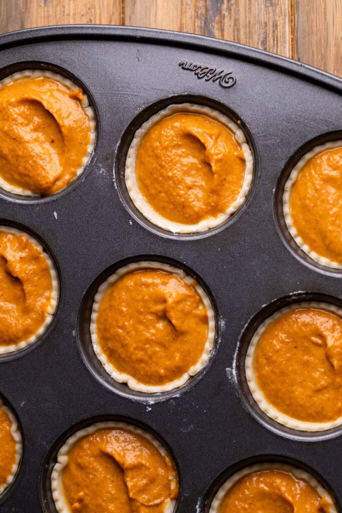 Pumpkin batter in the muffin pan.
