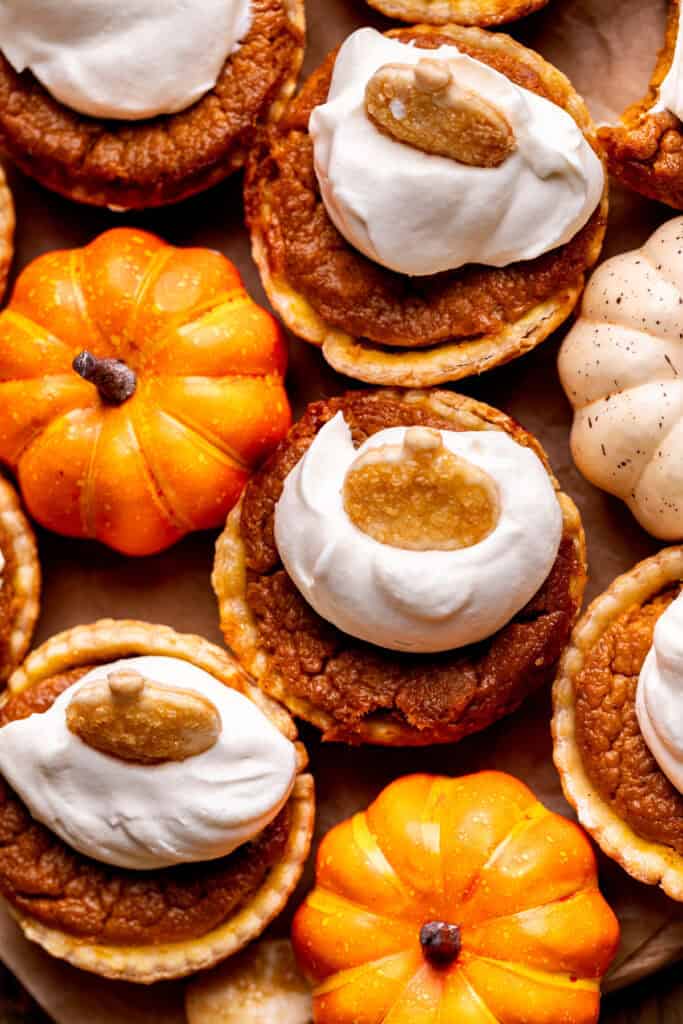 Mini pumpkin pies on a wood board.