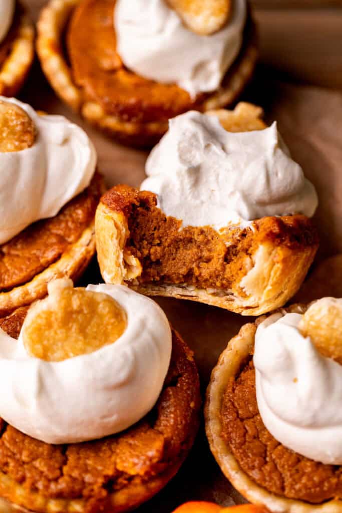 Top view of a bite missing from mini pumpkin pies.