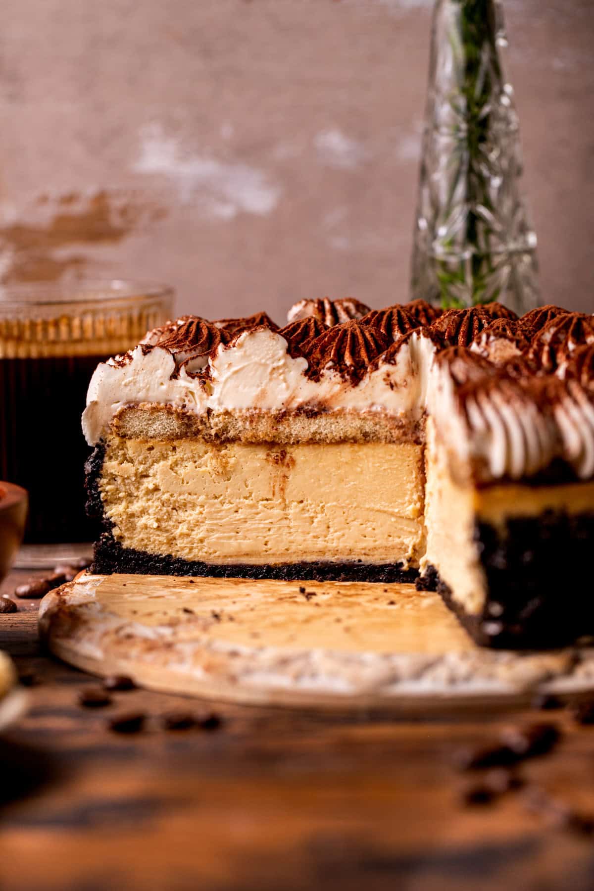 Side view of tiramisu cheesecake on a board.