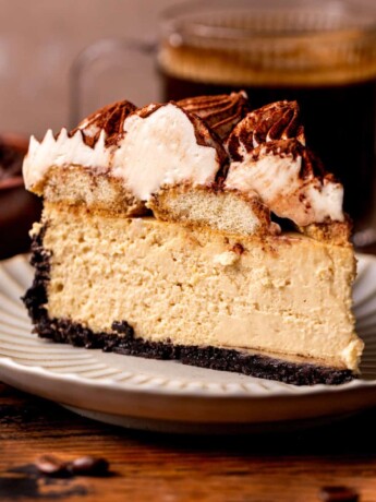 One slice of tiramisu cheesecake on a plate.