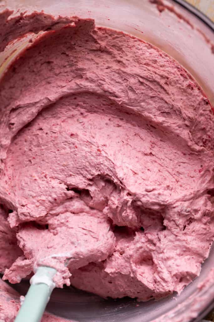 Raspberry mousse in a glass bowl.