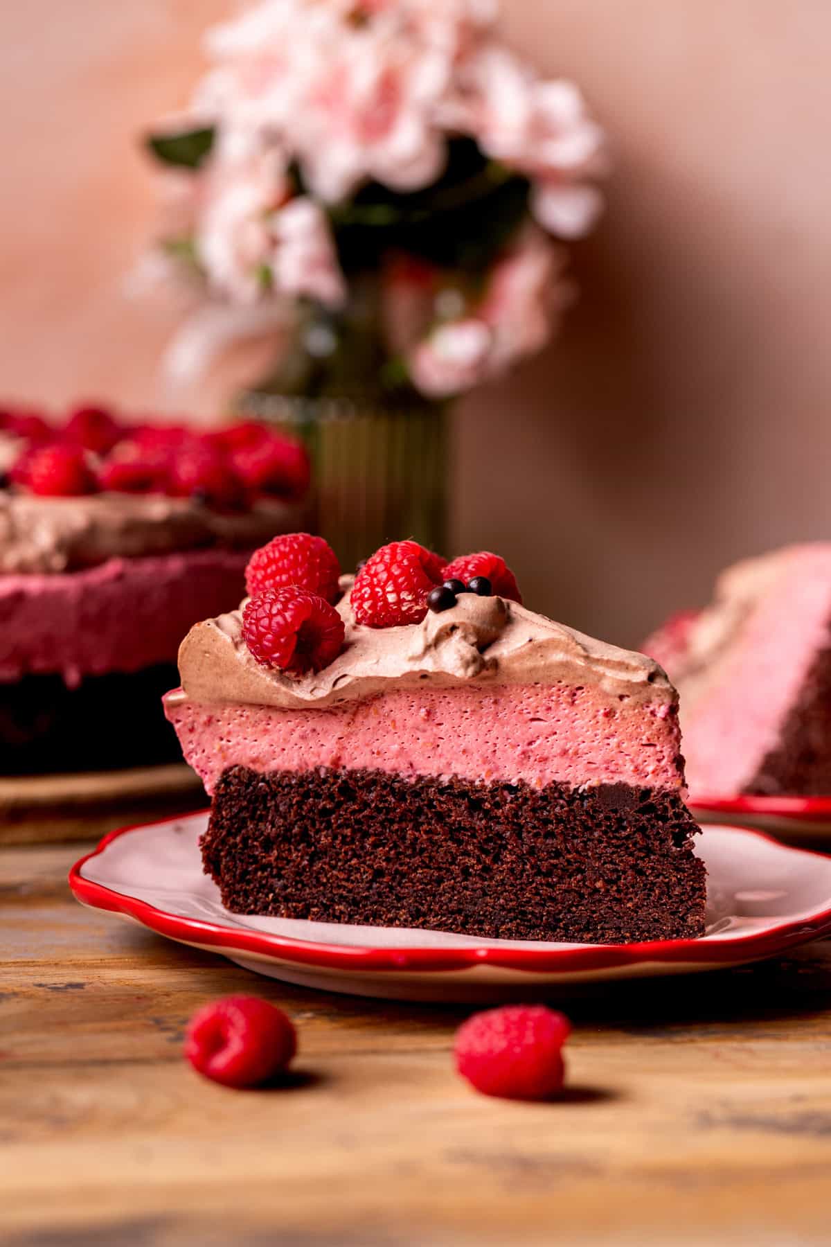 Slice of chocolate raspberry mousse cake on a plate.