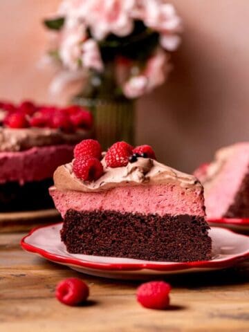 Slice of chocolate raspberry mousse cake on a plate.