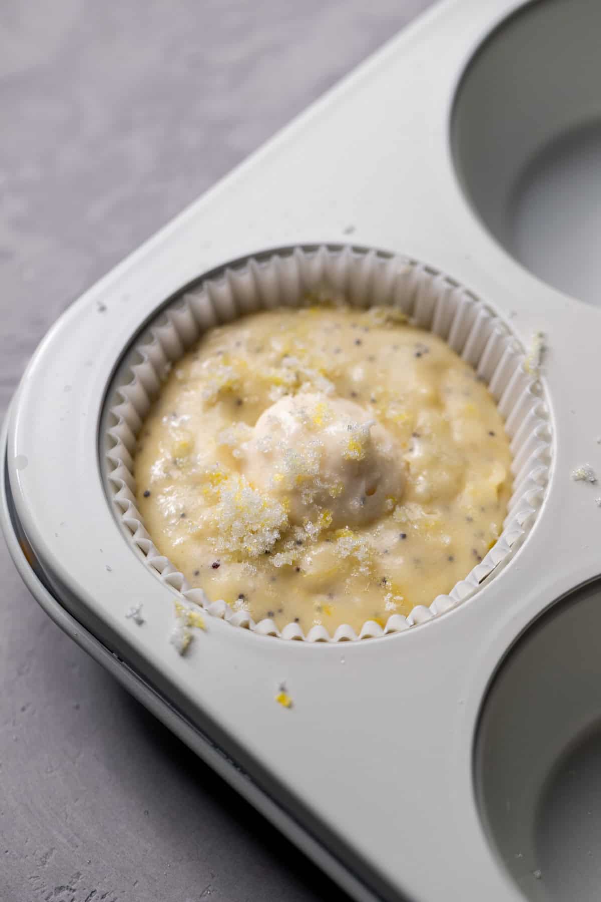 Cream cheese dollop on top of muffin batter.