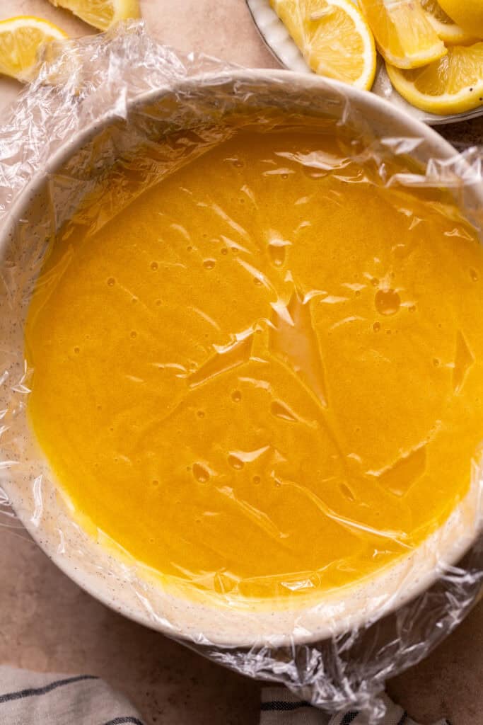 Plastic wrap over lemon curd.