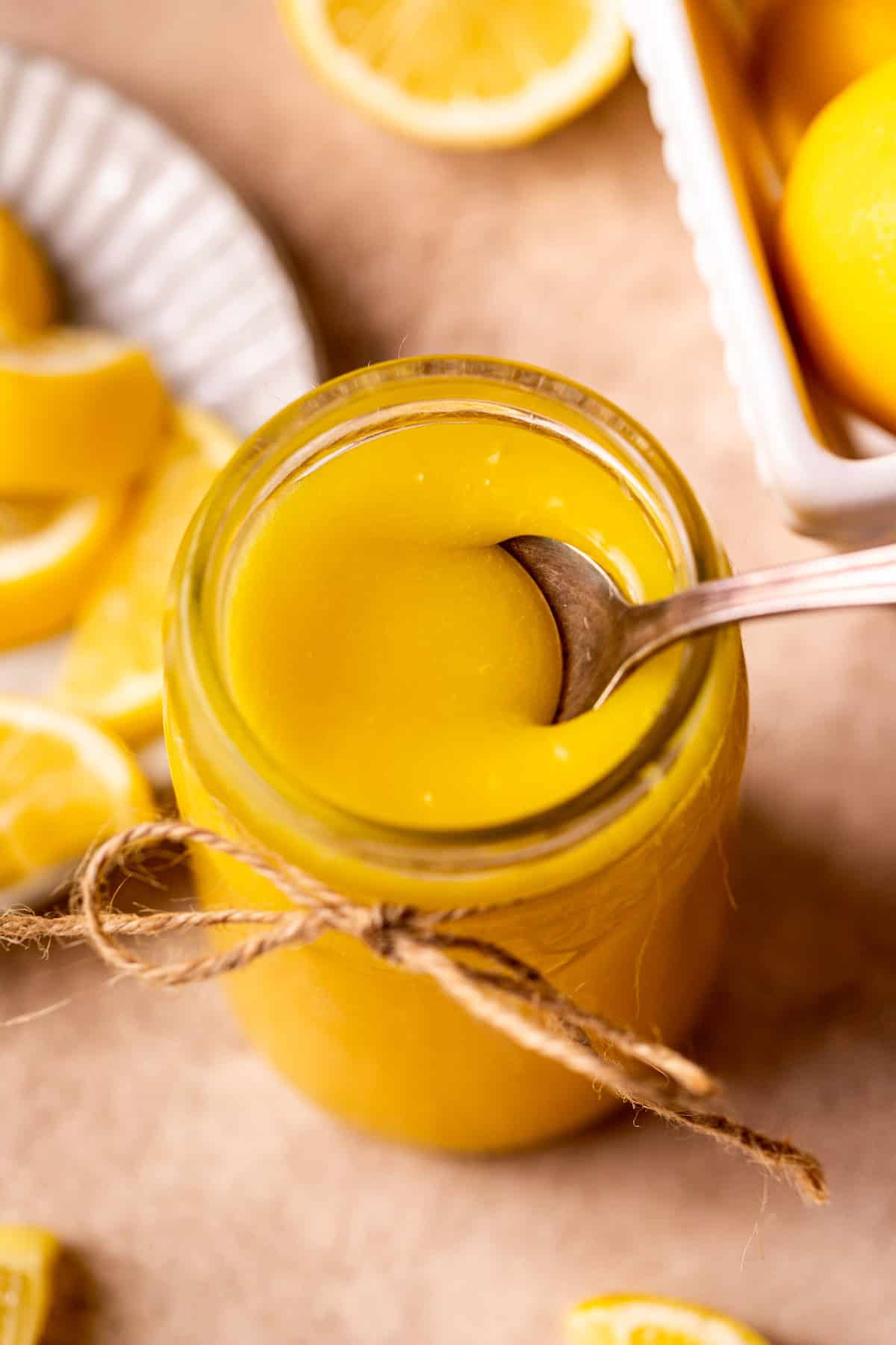 Spoon inserted in a jar of curd.