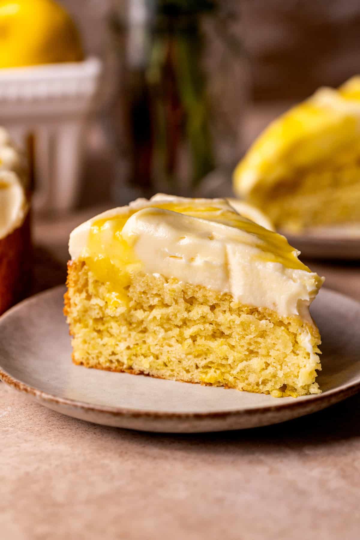 Slice of lemon curd cake on a plate.