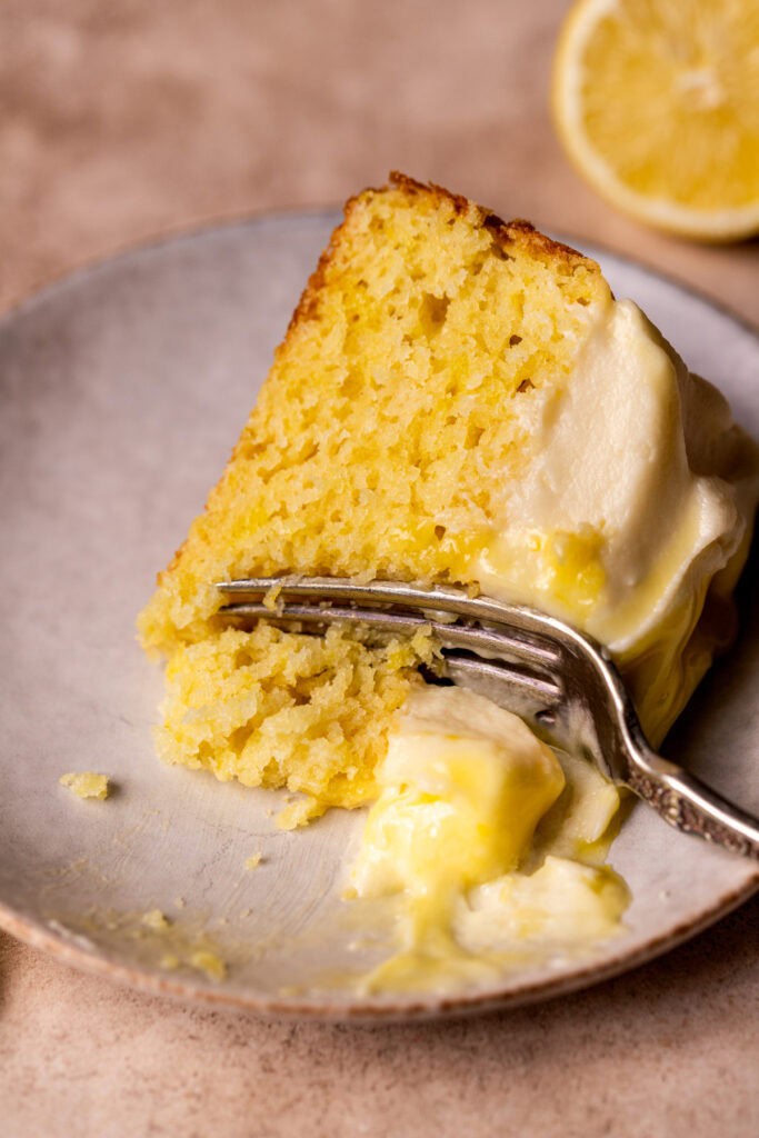 One slice of lemon curd cake on its side.